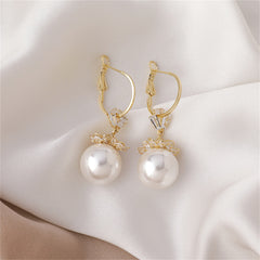 Stunning floral huggie earrings with white pearls and cubic zirconia, set in 18k gold plating for a luxurious touch.