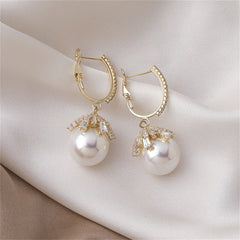 Stunning huggie earrings with white pearls and diamonds, set in luxurious 18K gold plating.