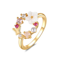 Elegant 18k gold-plated ring adorned with pink flowers and white stones, showcasing a beautiful open-circle floral design.