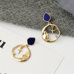 Stunning 18K gold-plated hoop earrings showcasing a crescent moon and cross, embellished with cubic zirconia.