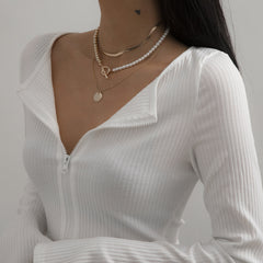 Beautiful layered necklace with a pearl and gold coin, crafted in 18K gold plating for a sophisticated touch.