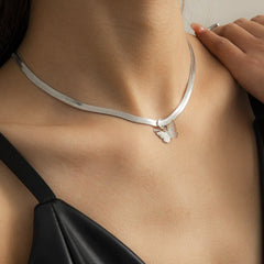 A woman models a silver-plated choker featuring a delicate butterfly charm on a snake chain.