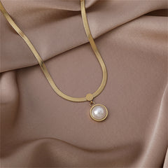 Delicate gold necklace adorned with a pearl, set on a sleek 18K gold-plated snake chain.
