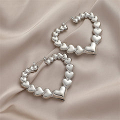 Charming silver heart-shaped hoop earrings, a delightful addition to any jewelry collection.