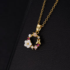 Beautiful Cat's Eye & Pearl necklace, gold-plated with pink flowers and crystals, radiating sophistication and style.
