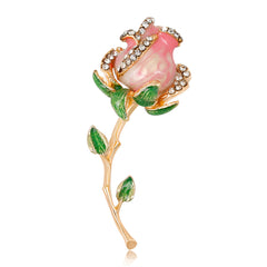 Luxurious pink rose brooch with green leaves, crafted from 18K gold-plated metal and embellished with cubic zirconia.