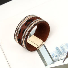 Luxurious leopard print leather cuff bracelet with a gold-plated clasp, embellished with 18K gold plating and sparkling cubic zirconia.