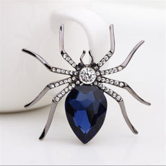 Stunning blue spider brooch embellished with diamonds, highlighting a creative and eye-catching accessory.