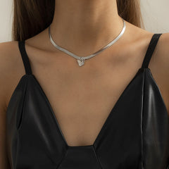 Close-up of a woman wearing a silver snake chain choker adorned with a butterfly charm.