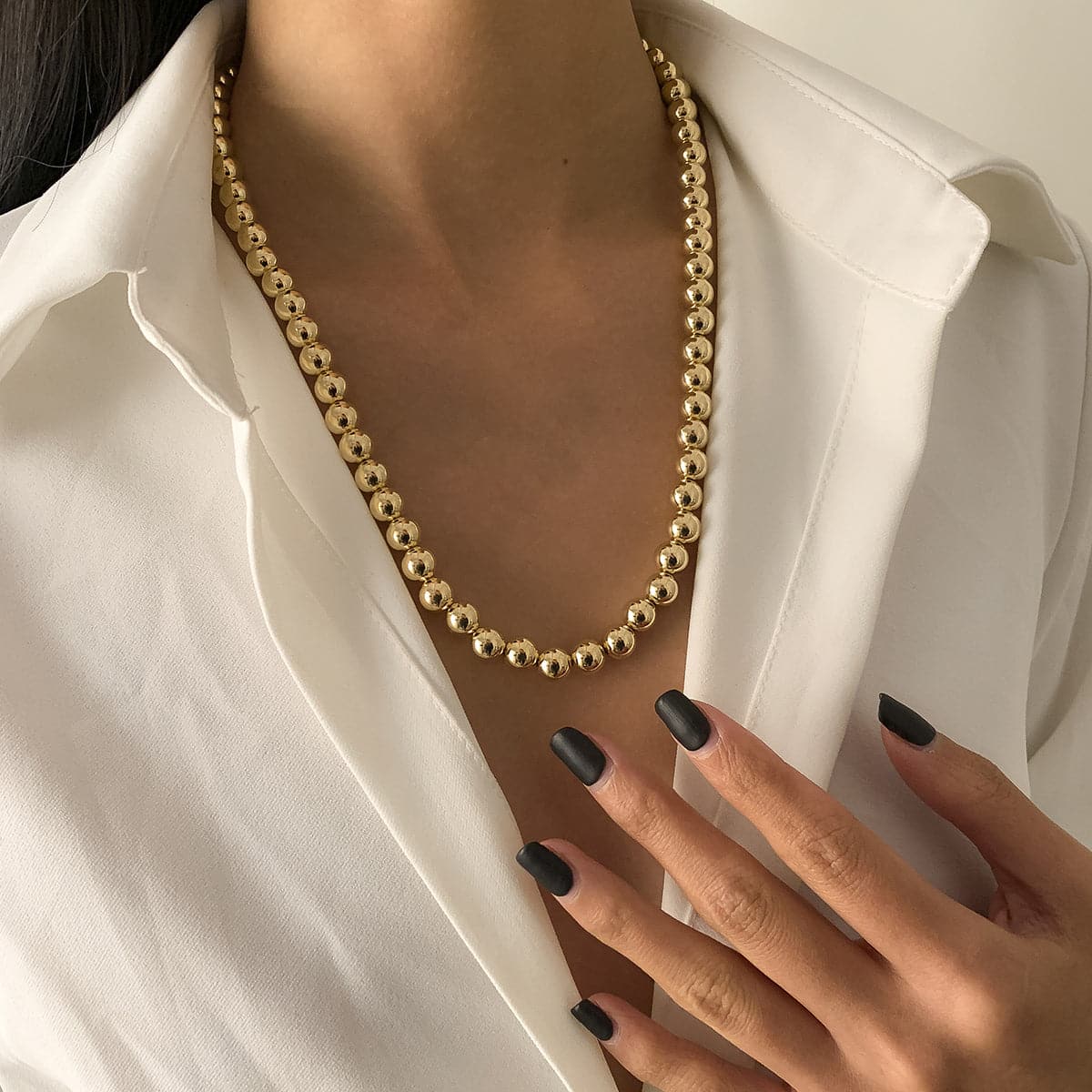 Elegant 18K gold-plated bead chain necklace featuring a single strand of shimmering gold beads.