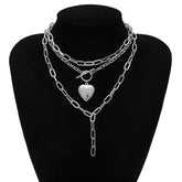 Elegant silver chain necklace with a heart charm, showcasing a layered design for a stylish accessory.