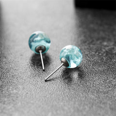 Charming blue and white marble stud earrings, evoking a serene cloud-like appearance for a trendy touch.