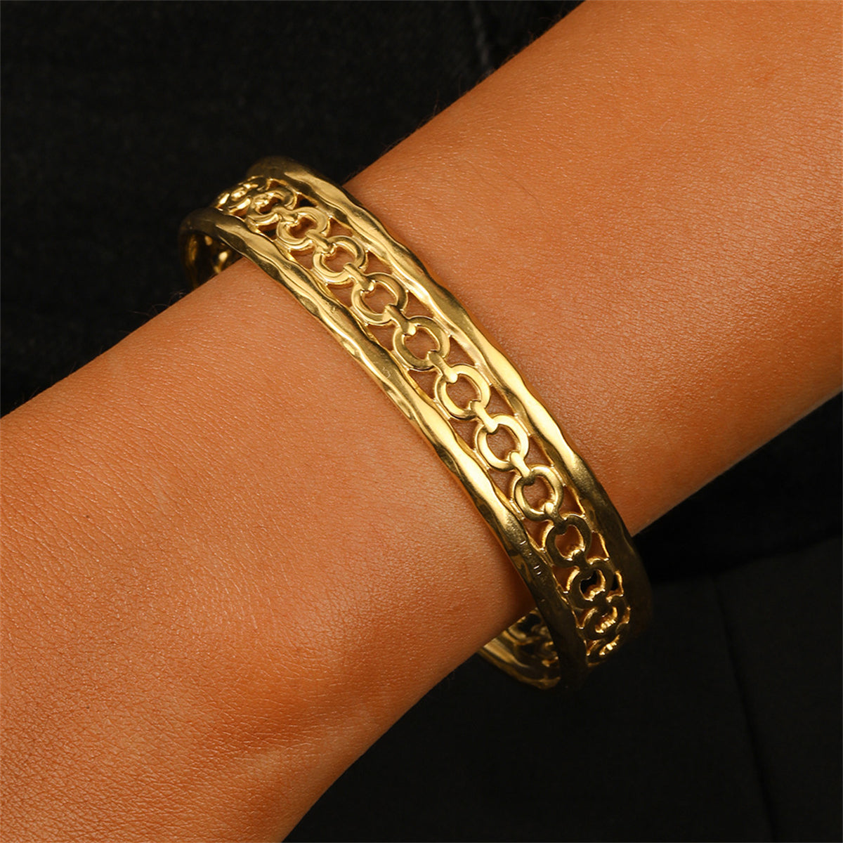 Elegant 18K gold-plated cable cuff bracelet featuring intricate designs, perfect for adding a touch of luxury to any outfit.
