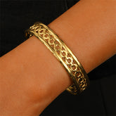 Elegant 18K gold-plated cable cuff bracelet featuring intricate designs, perfect for adding a touch of luxury to any outfit.