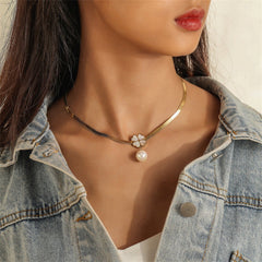 Stunning gold necklace with a pearl and heart charm, featuring a clover pendant on a sleek 18K gold-plated snake chain.