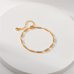 A stylish 18K gold-plated bracelet with a gold chain and a small decorative ball at the end.
