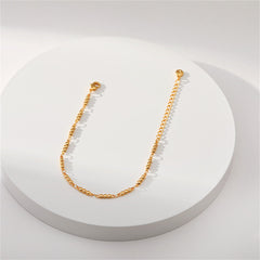An elegant gold chain bracelet adorned with a small ball, crafted in 18K gold plating for a luxurious touch.