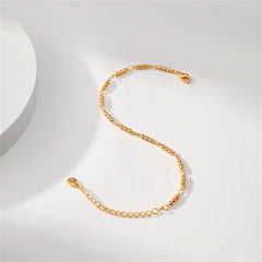 An 18K gold-plated beaded bracelet with a delicate gold chain and a small ball accentuating its end.
