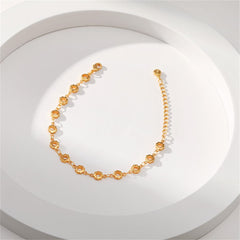Elegant 18K gold-plated bracelet with small circular links and a chain, adorned with open flower stations.
