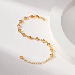 18K gold-plated bracelet showcasing small circles and a chain, embellished with open flower designs.