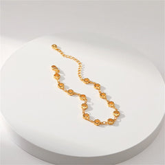 A refined 18K gold-plated bracelet composed of small circles and a chain, featuring open flower stations.