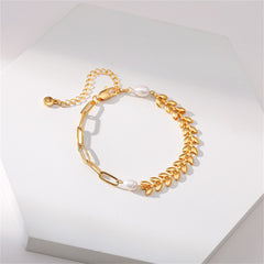 An 18K gold-plated wheat chain bracelet adorned with a leaf charm and lustrous pearl beads, showcasing refined elegance.