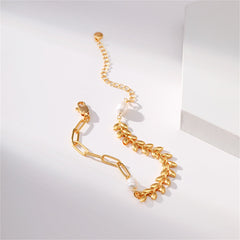 An elegant bracelet made of 18K gold-plated wheat chain, embellished with a leaf charm and beautiful pearl beads.