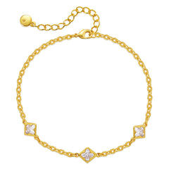 A gold-plated bracelet adorned with diamonds and a clover charm, showcasing elegance and luxury in design.
