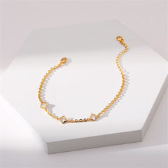 Gold-plated bracelet embellished with diamonds and a clover charm, representing style and refinement.