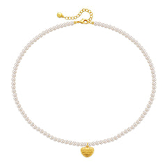 A delicate white pearl necklace with a gold heart charm, highlighted by an 18K gold-plated 'Love You' pendant.