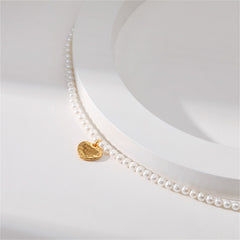 Elegant white pearl necklace adorned with a gold heart charm, showcasing an 18K gold-plated 'Love You' pendant.