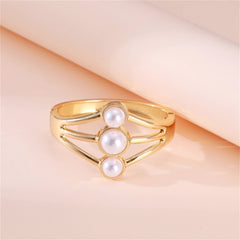 A stylish gold-plated bangle with three white pearls, designed in a chic layered bangle fashion for a modern look.