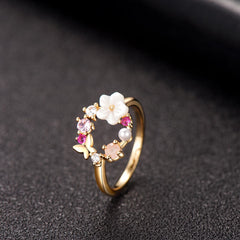 Beautiful 18k gold-plated ring featuring pink flowers and white stones, crafted in a charming open-circle floral design.