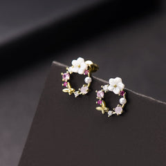 Gold-plated pink flower earrings showcasing opal and cubic zirconia butterflies, perfect for a stylish look.