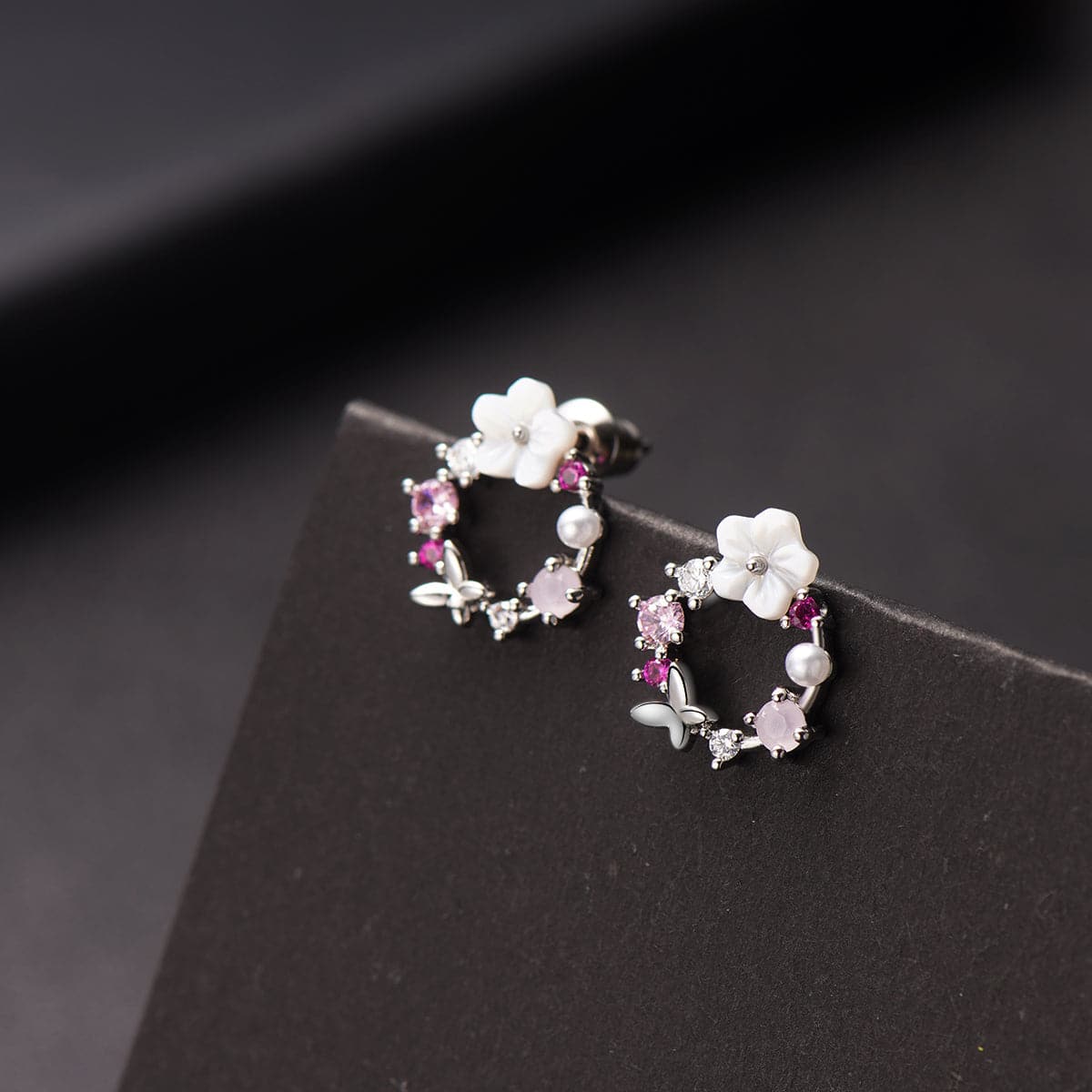 Pink flower earrings adorned with white stones, featuring opal and cubic zirconia in a butterfly and floral design.