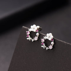 Pink flower earrings adorned with white stones, featuring opal and cubic zirconia in a butterfly and floral design.