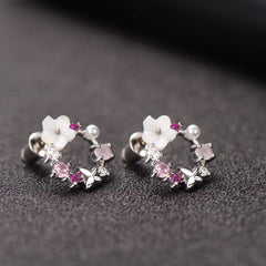 Elegant pink flower earrings with white stones, showcasing opal and cubic zirconia in a butterfly and floral style.