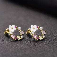Charming pink flower earrings with gold accents, featuring delicate opal and cubic zirconia butterfly details.