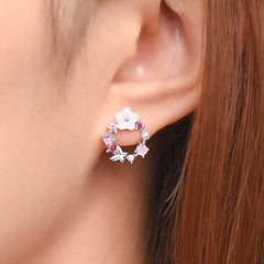 Delicate pink flower earrings embellished with white stones, featuring a butterfly and floral design in opal and cubic zirconia.