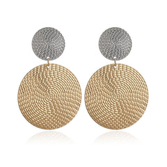 Beautiful woven disk drop earrings crafted from 18K gold and silver, featuring a chic circular disc design.