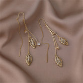 Elegant gold leaf earrings featuring crystal stones, designed as Cats Eye & 18K gold-plated double leaf ear threaders.