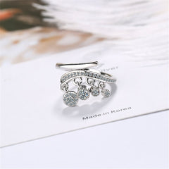 Stunning silver bypass ring with three sparkling diamonds and a delicate chain tassel for added flair.