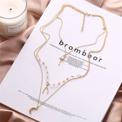 Elegant three-layered gold necklaces with a star, moon, and star, beautifully designed in 18K gold plating.