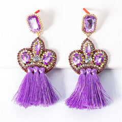 Eye-catching purple tassel earrings with gold and purple crystals, designed as fringe drops adorned with shimmering cubic zirconia.