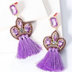 Chic purple tassel earrings featuring gold and purple crystals, designed as fringe drops with elegant cubic zirconia embellishments.