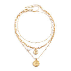 Elegant layered necklace set with a gold-plated coin and pearl accents on a stylish cable chain.