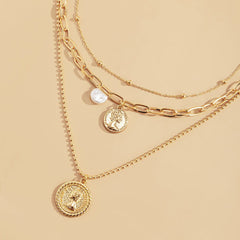 Chic layered necklace showcasing a coin pendant and pearl details, crafted in 18K gold plating.