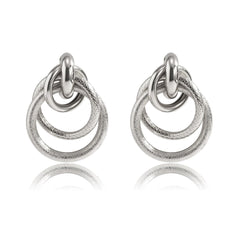 Two silver drop earrings featuring layered circular designs, elegantly crafted for a stylish look.