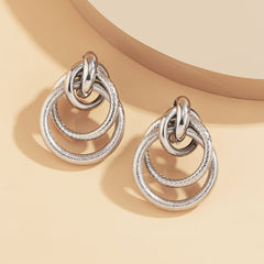 Elegant silver-plated drop earrings featuring layered circles, perfect for a chic and sophisticated appearance.