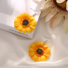 Charming yellow sunflower drop earrings with dark black centers, perfect for adding a floral touch to any outfit.